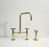 Gold kitchen faucet set on a white background